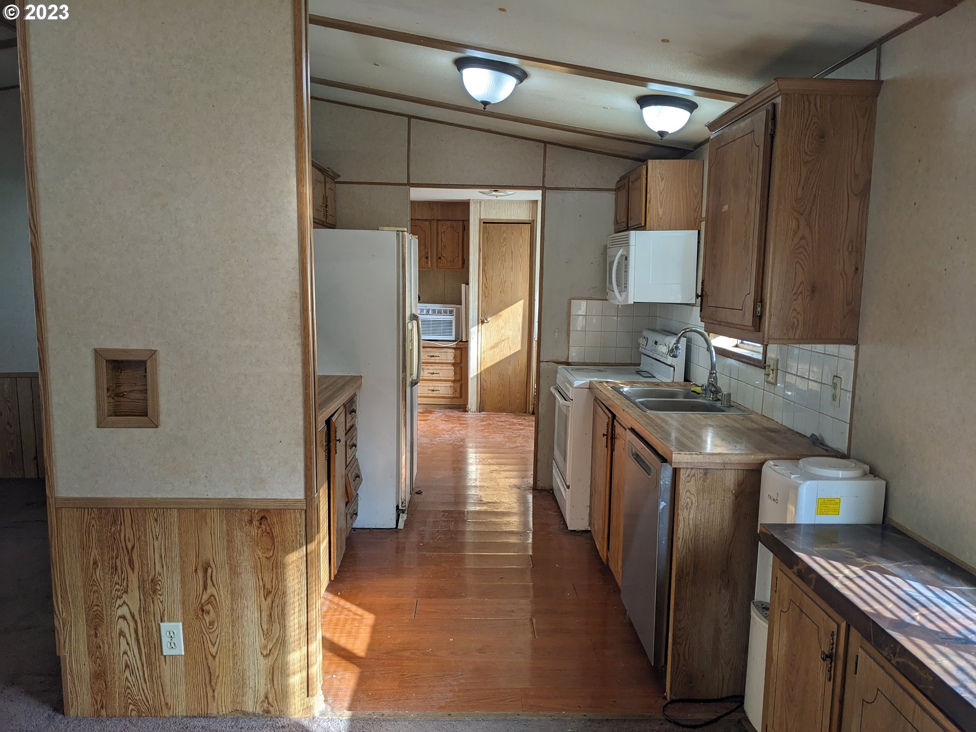 32905 James Street, Unit 20 Scappoose, OR 97056 - Photo 3 of 8 a kitchen with stainless steel appliances granite countertop a refrigerator a stove and a sink