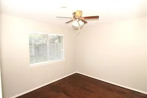 a view of a room with a window and a ceiling fan