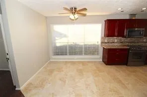a view of kitchen with granite countertop cabinets and outdoor space