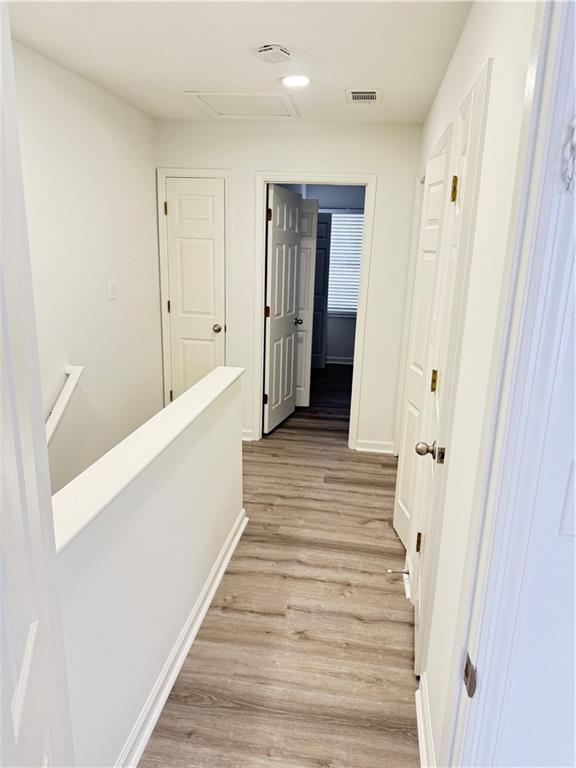 2356 Cove Road Lithonia, GA 30058 - Photo 16 of 20 a view of a hallway with wooden floor and staircase