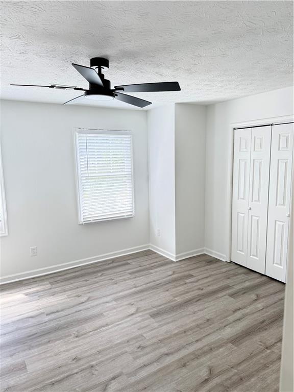2356 Cove Road Lithonia, GA 30058 - Photo 17 of 20 a view of an empty room with wooden floor and a window