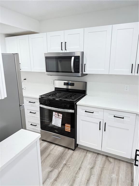 2356 Cove Road Lithonia, GA 30058 - Photo 5 of 20 a kitchen with cabinets appliances and a counter space