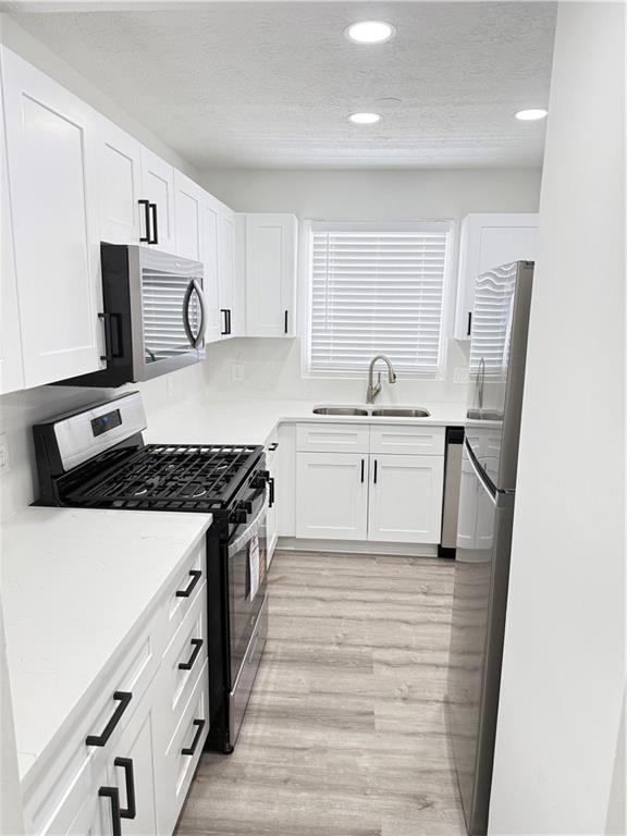 2356 Cove Road Lithonia, GA 30058 - Photo 6 of 20 a kitchen with stainless steel appliances granite countertop a sink stove and refrigerator
