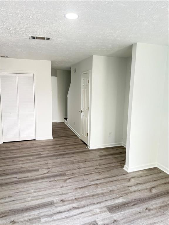 2356 Cove Road Lithonia, GA 30058 - Photo 8 of 20 a view of an empty room with wooden floor