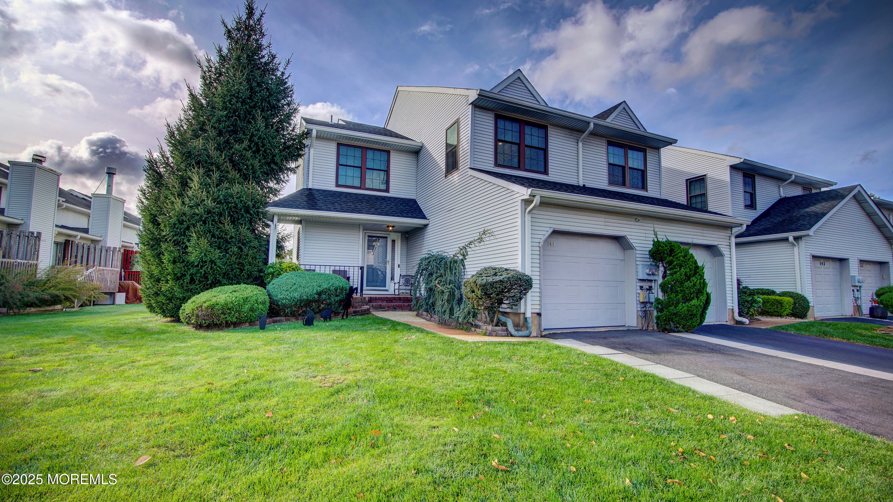 141 Chestnut Way, Unit 141 Manalapan, NJ 07726 - Photo 1 of 46 a view of a house with a yard and plants
