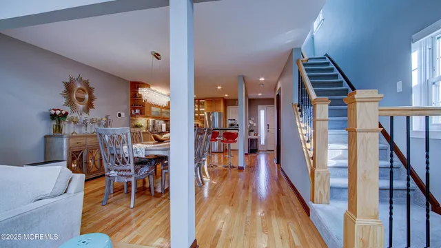 a view of a hallway with furniture and wooden floor