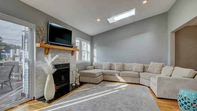 a living room with furniture a fireplace and a flat screen tv