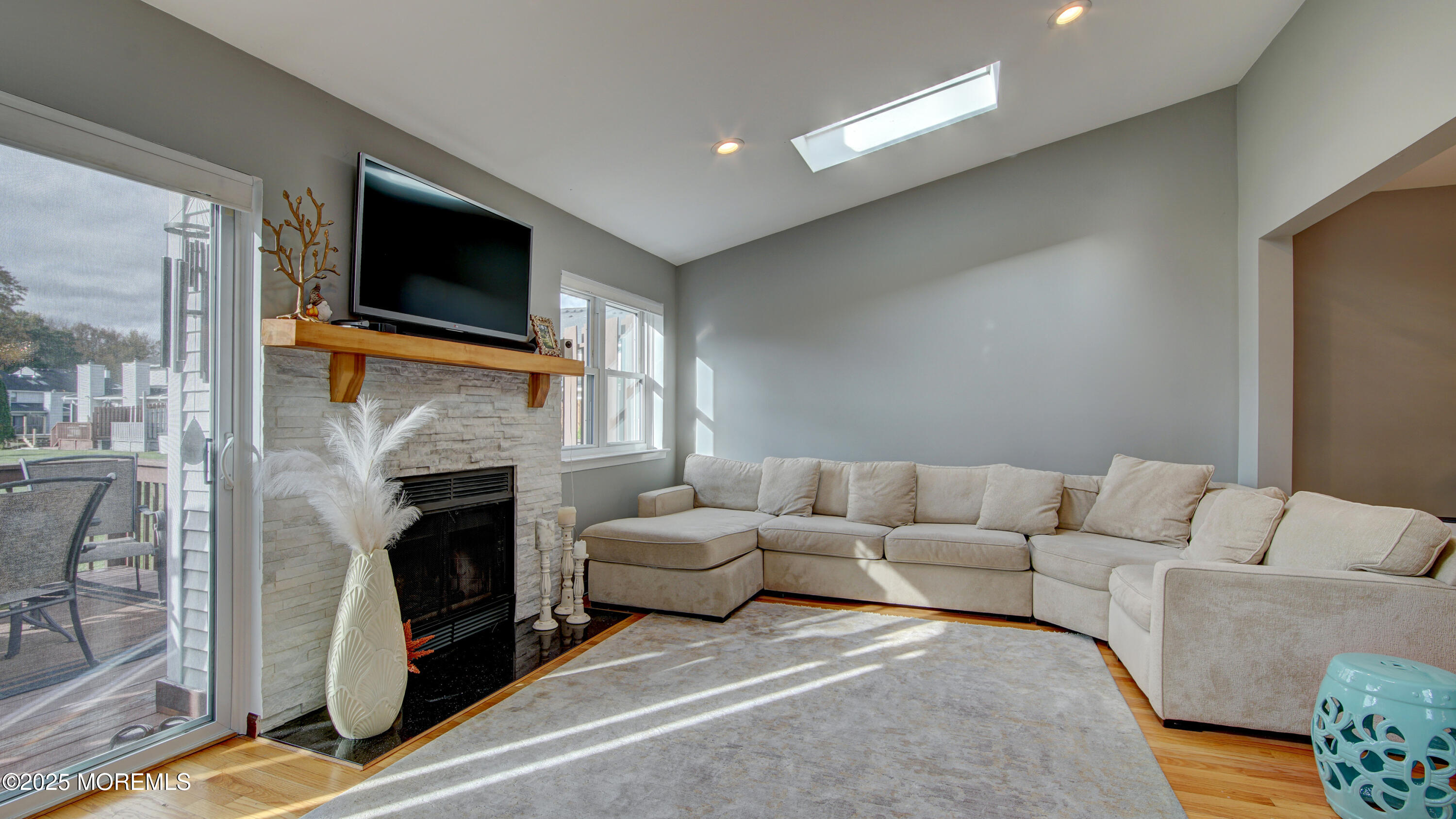 141 Chestnut Way, Unit 141 Manalapan, NJ 07726 - Photo 17 of 46 a living room with furniture a fireplace and a flat screen tv