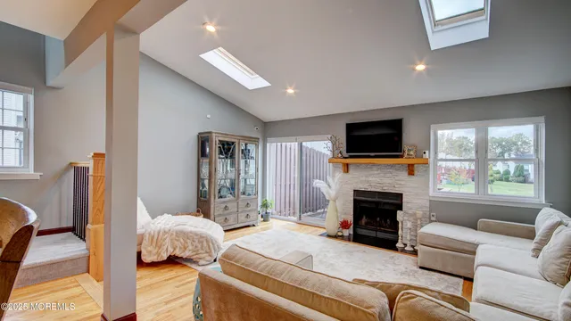 a living room with furniture flat screen tv and a fireplace