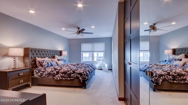 a bedroom with a large bed and a chandelier