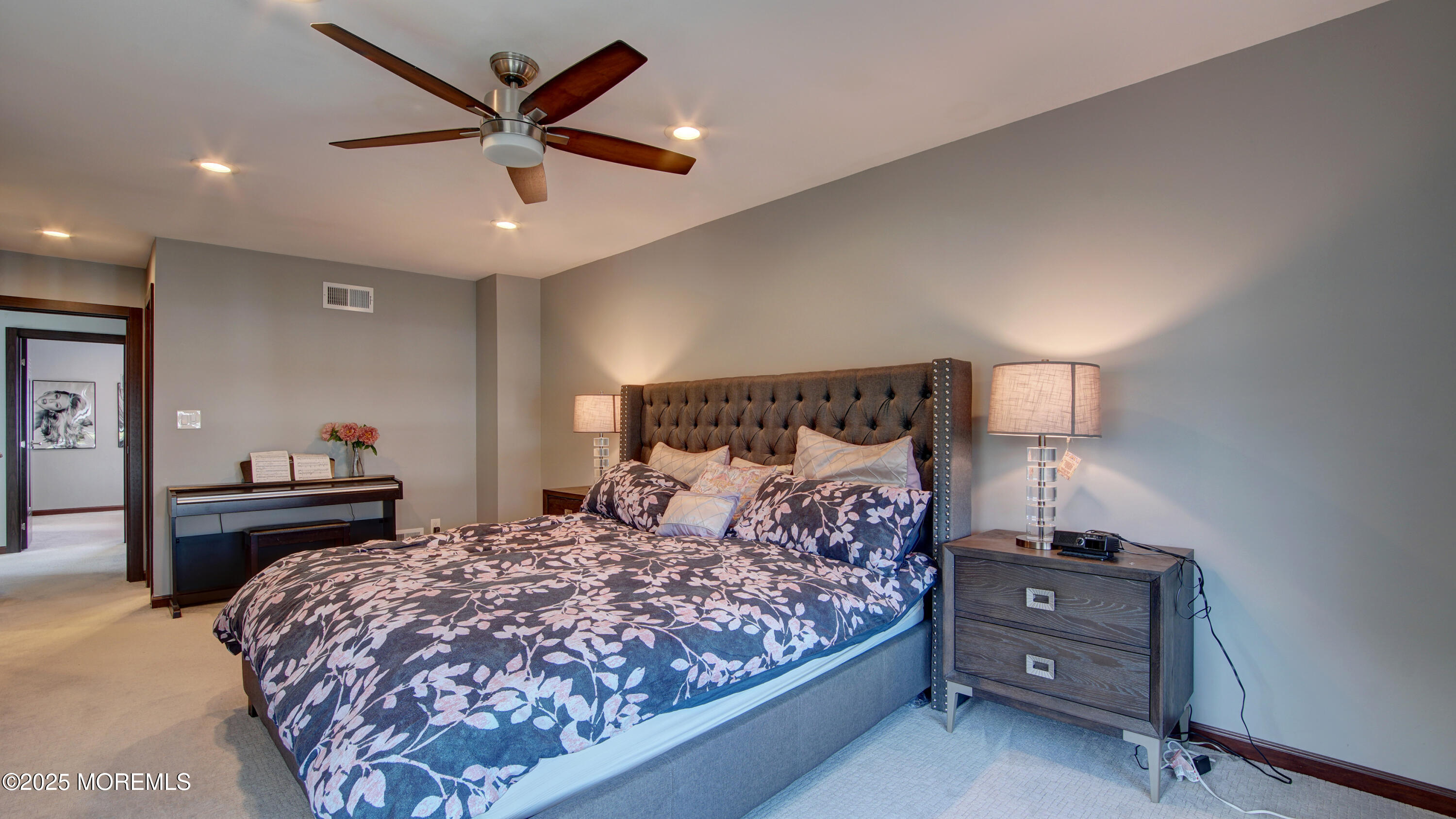 141 Chestnut Way, Unit 141 Manalapan, NJ 07726 - Photo 24 of 46 a bedroom with a bed and a chandelier