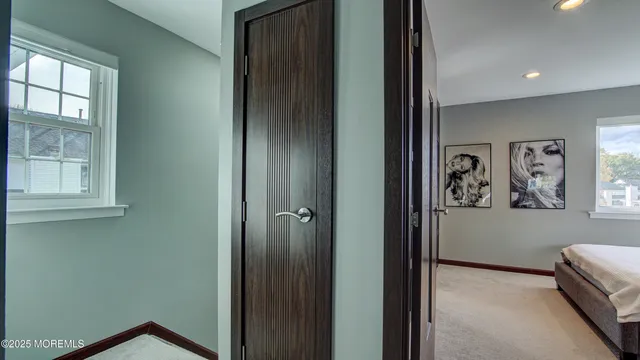 a view of a hallway with windows and closet