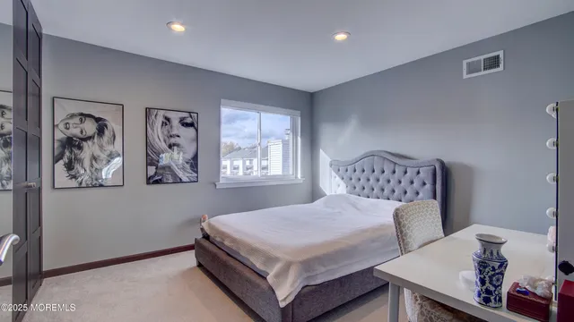 a bedroom with a bed and wall painting