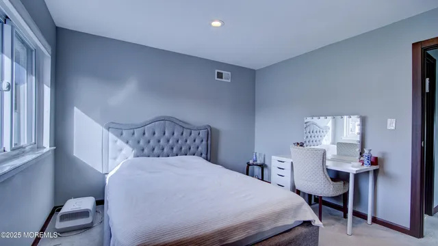 a bedroom with a bed and a table