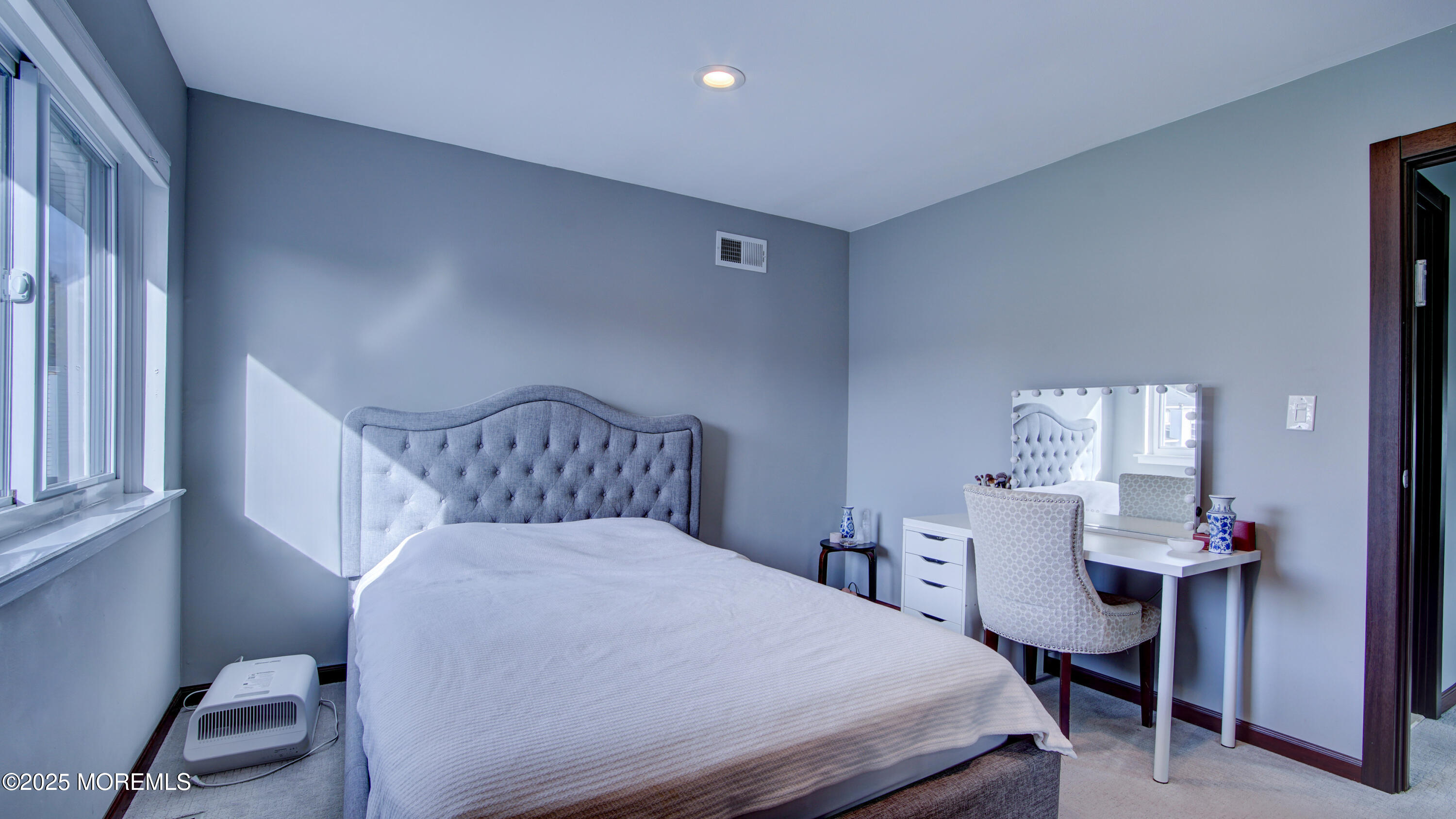 141 Chestnut Way, Unit 141 Manalapan, NJ 07726 - Photo 31 of 46 a bedroom with a bed and a table