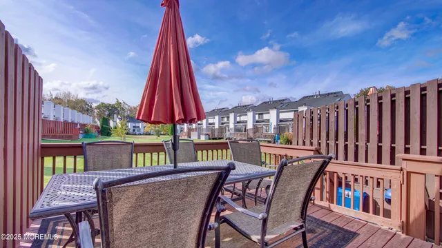 a view of a chairs and table in the balcony