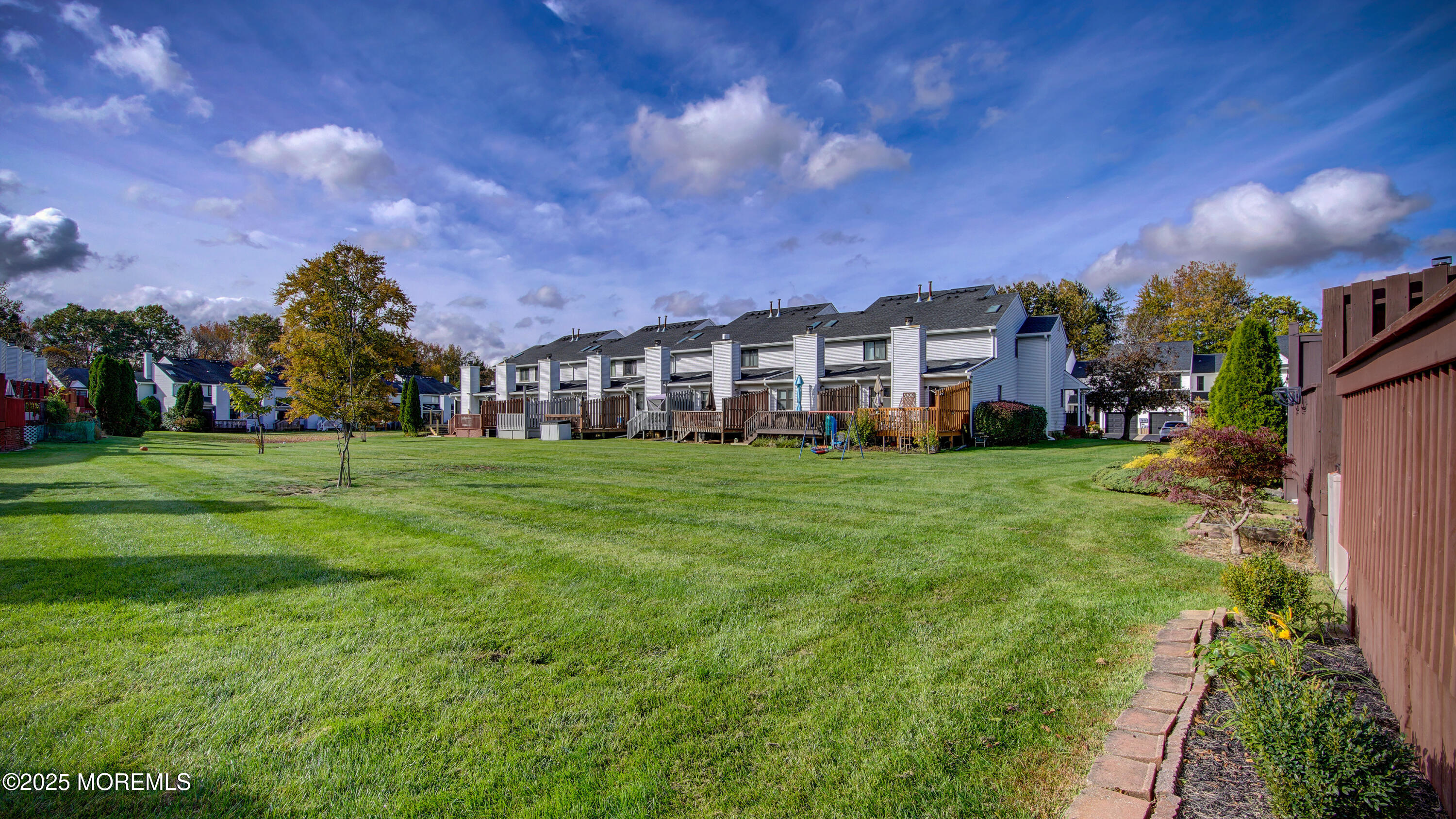 141 Chestnut Way, Unit 141 Manalapan, NJ 07726 - Photo 41 of 46 a view of a house with a big yard and large trees