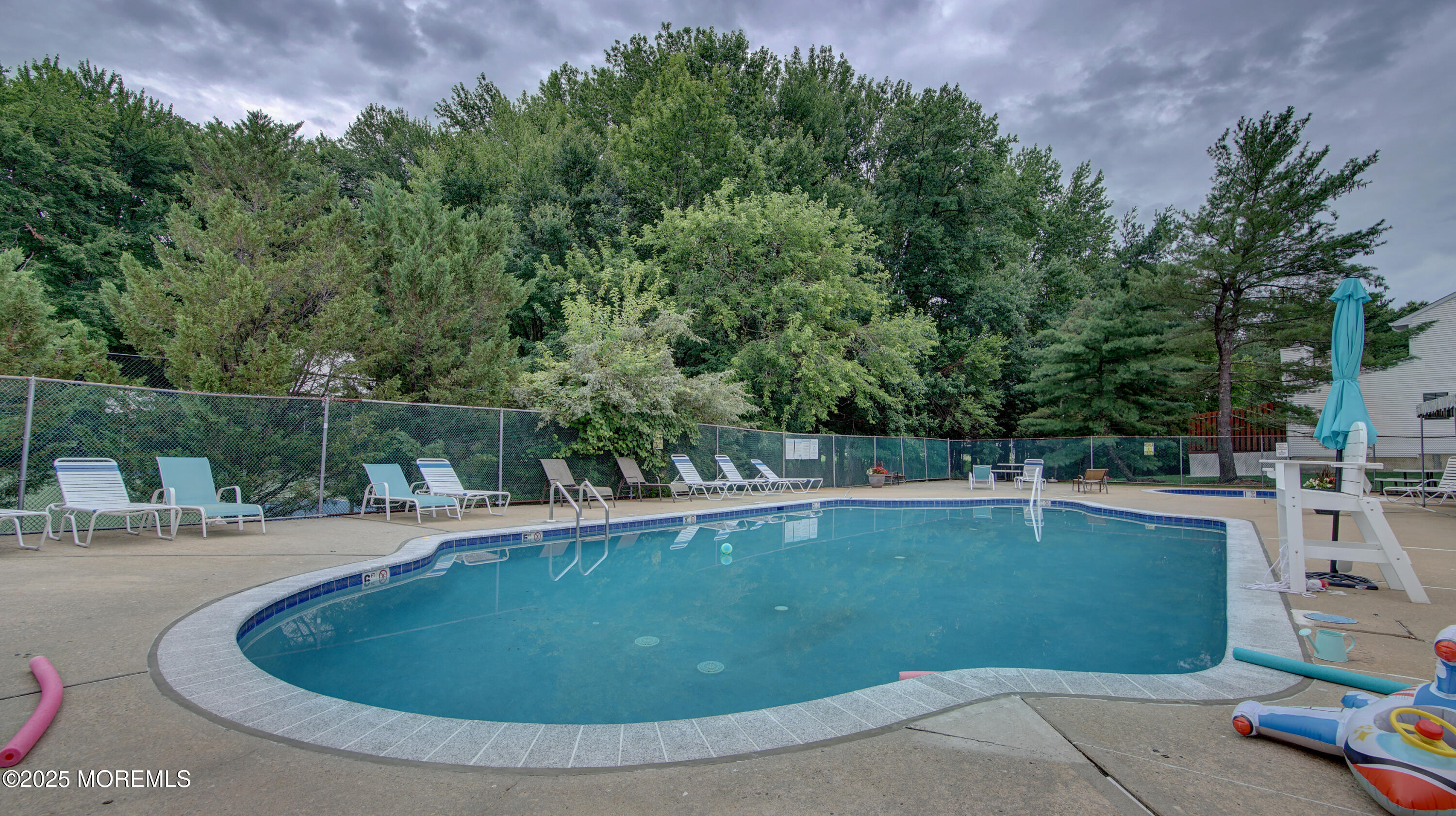 141 Chestnut Way, Unit 141 Manalapan, NJ 07726 - Photo 43 of 46 a view of a swimming pool with a yard and sitting area