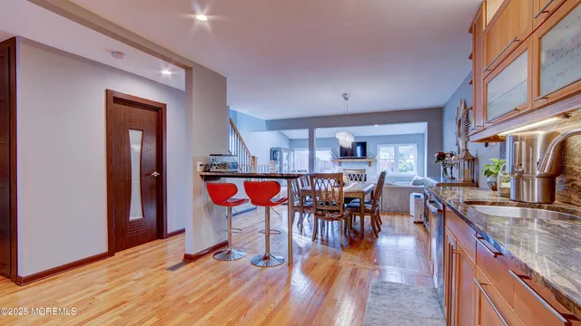 a dining room with furniture and wooden floor