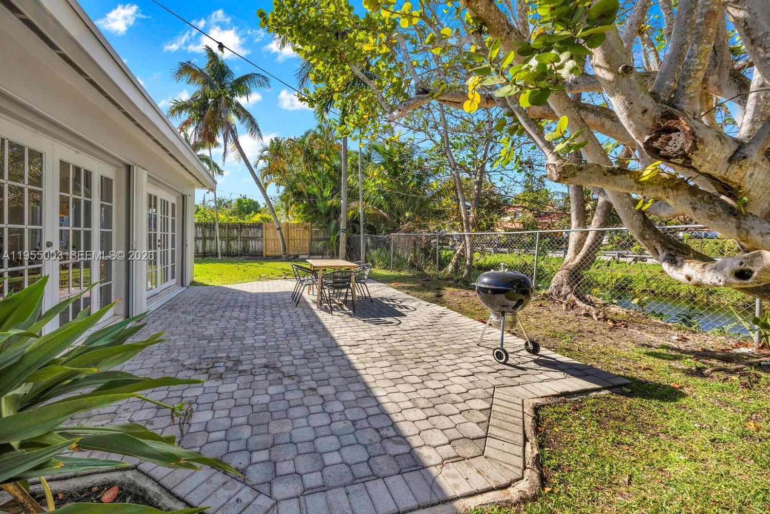 8230 Southwest 63rd Place Miami, FL 33143 - Photo 16 of 24 a view of a yard with plants and large trees