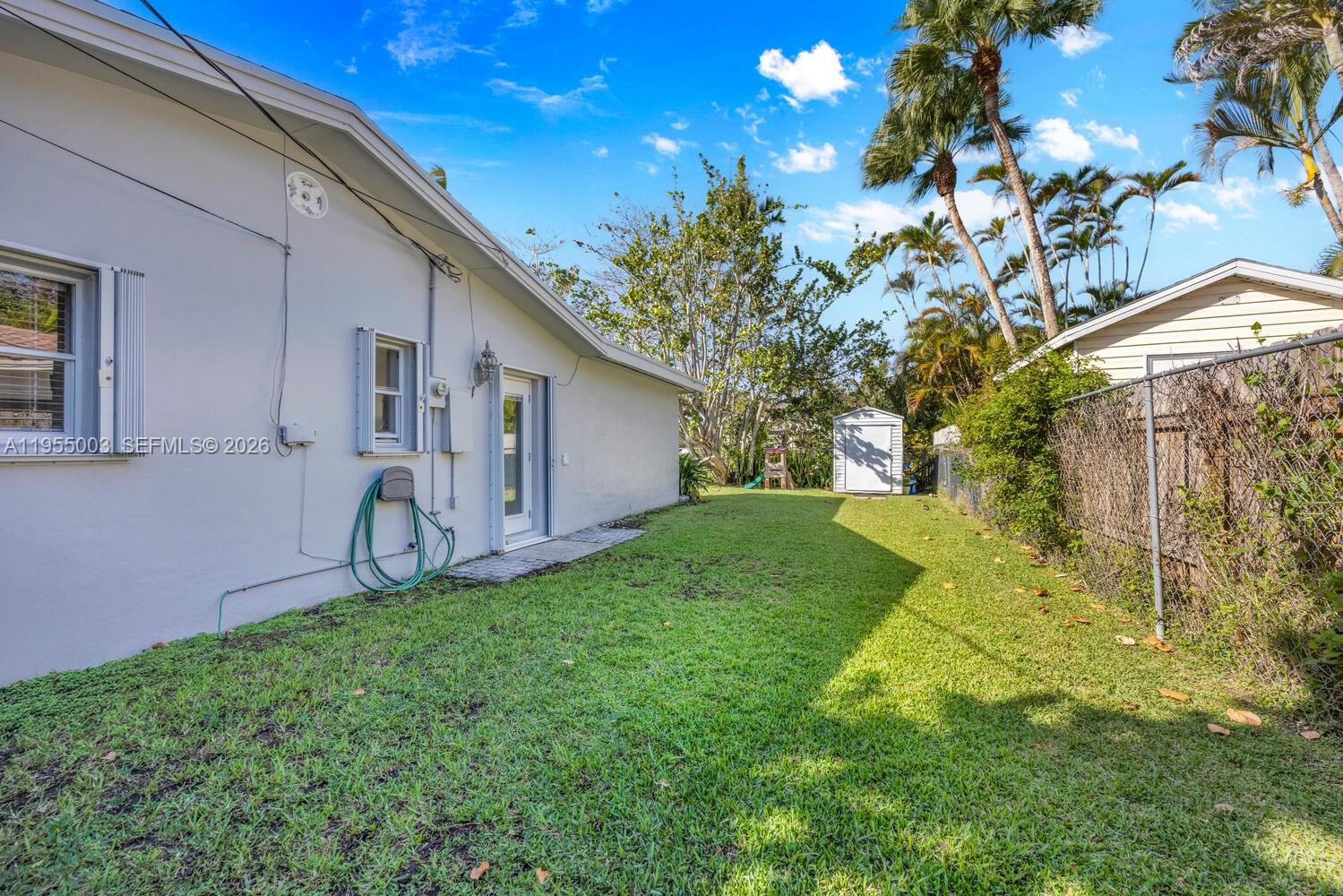 8230 Southwest 63rd Place Miami, FL 33143 - Photo 21 of 24 a backyard of a house with table and chairs
