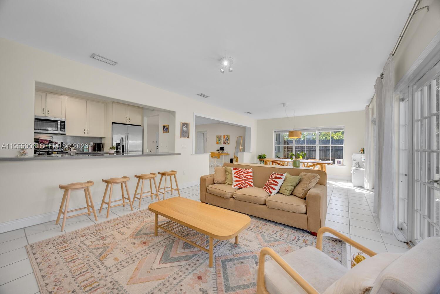 8230 Southwest 63rd Place Miami, FL 33143 - Photo 23 of 24 a living room with furniture and a table