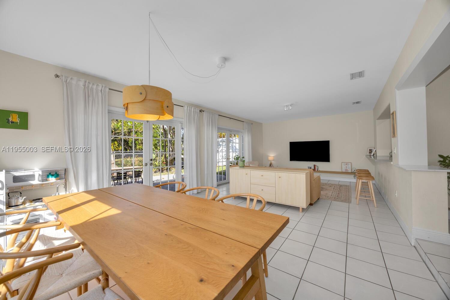 8230 Southwest 63rd Place Miami, FL 33143 - Photo 5 of 24 a bedroom with a large bed and a flat tv screen on dresser