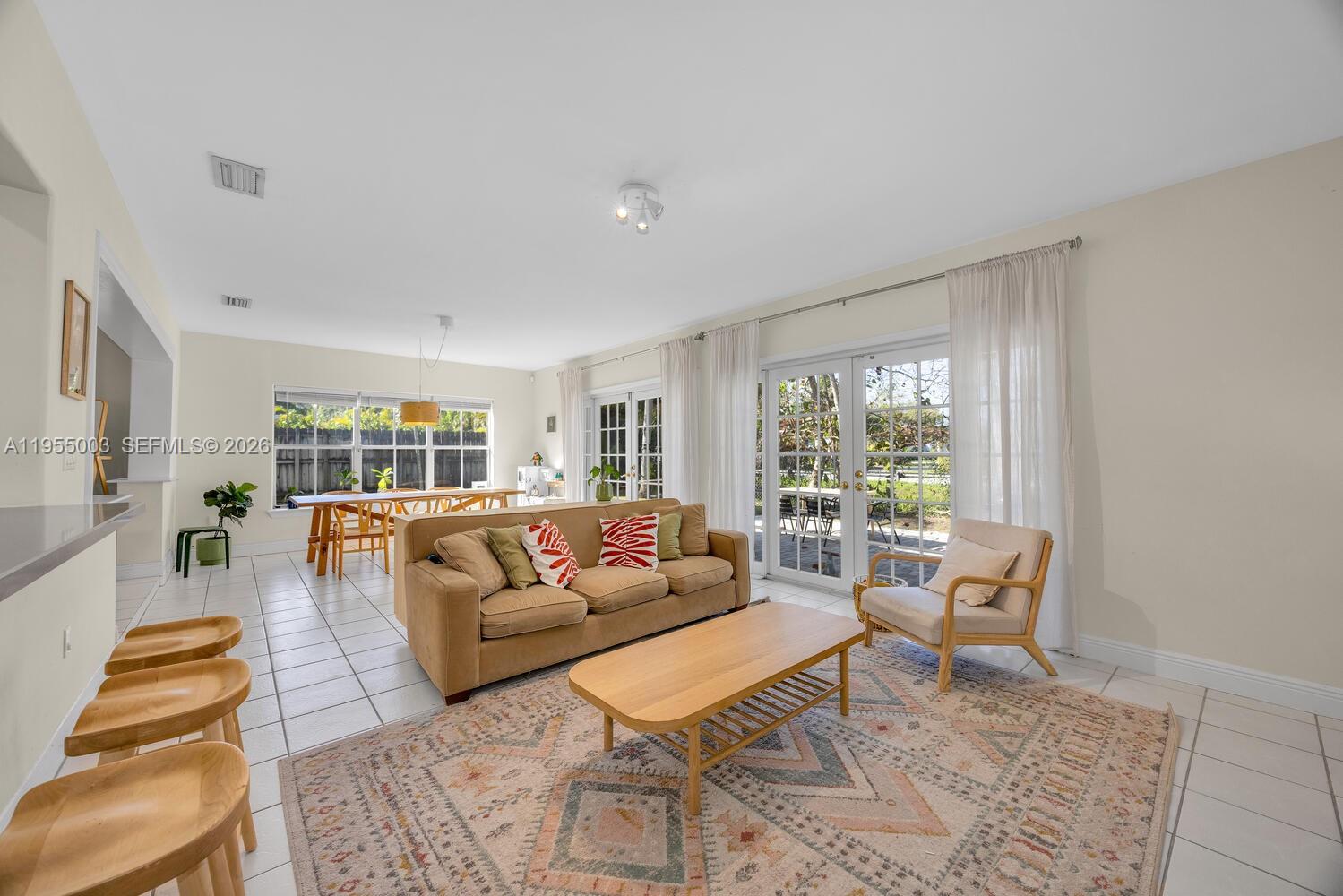 8230 Southwest 63rd Place Miami, FL 33143 - Photo 6 of 24 a living room with furniture and a large window