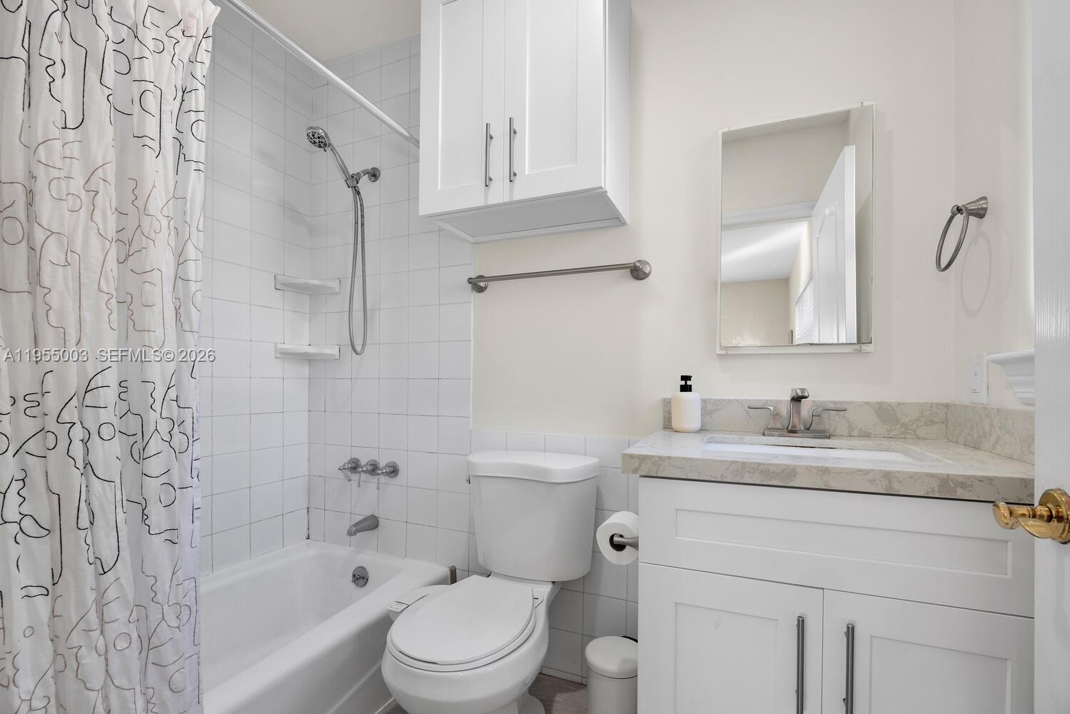 8230 Southwest 63rd Place Miami, FL 33143 - Photo 10 of 24 a bathroom with a granite countertop sink toilet and shower