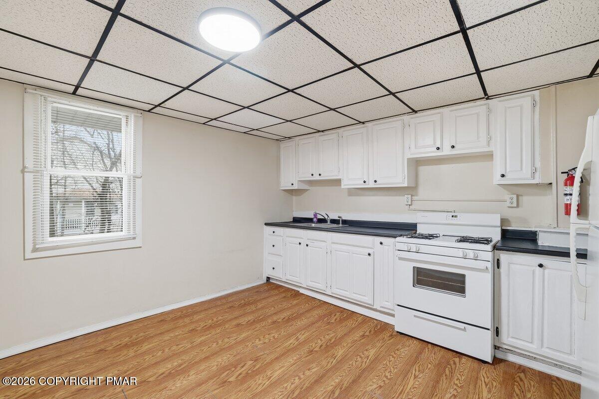 515 Breck Street Scranton, PA 18505 - Photo 18 of 38 a kitchen with granite countertop white cabinets and white appliances