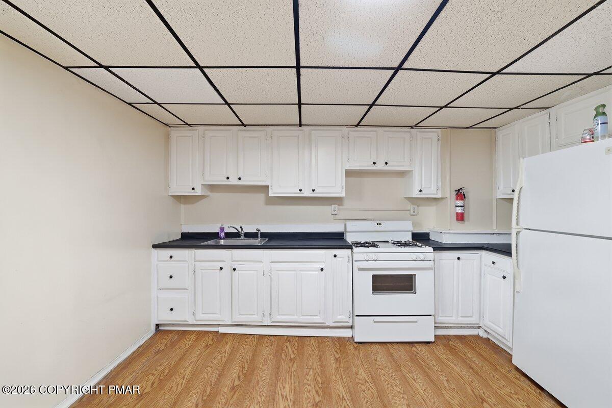 515 Breck Street Scranton, PA 18505 - Photo 19 of 38 a kitchen with stainless steel appliances a stove a sink and white cabinets