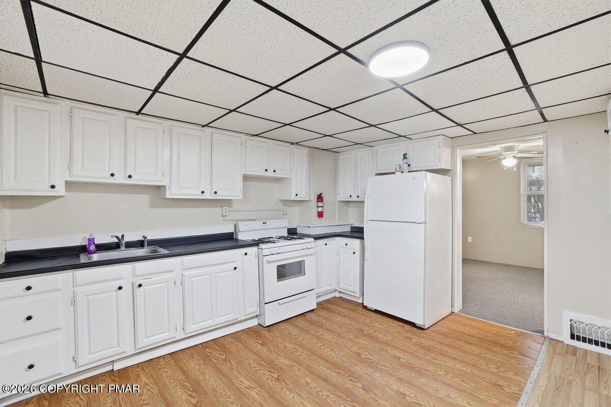 515 Breck Street Scranton, PA 18505 - Photo 20 of 38 a kitchen with white cabinets and white appliances