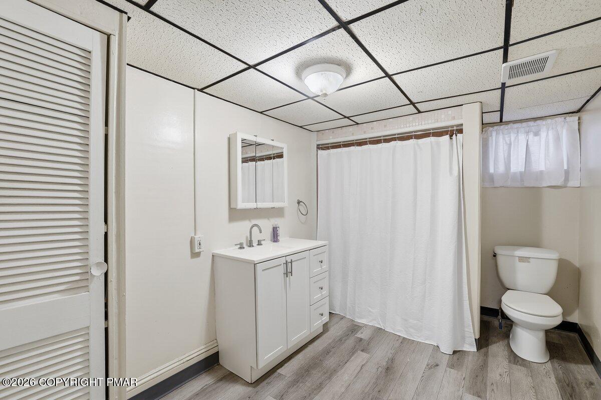 515 Breck Street Scranton, PA 18505 - Photo 25 of 38 a bathroom with a toilet a sink and a window