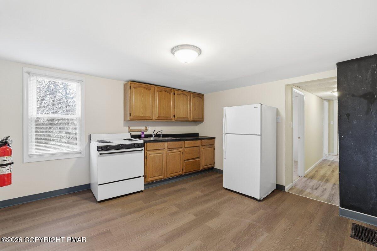 515 Breck Street Scranton, PA 18505 - Photo 29 of 38 a kitchen with a refrigerator and white cabinets