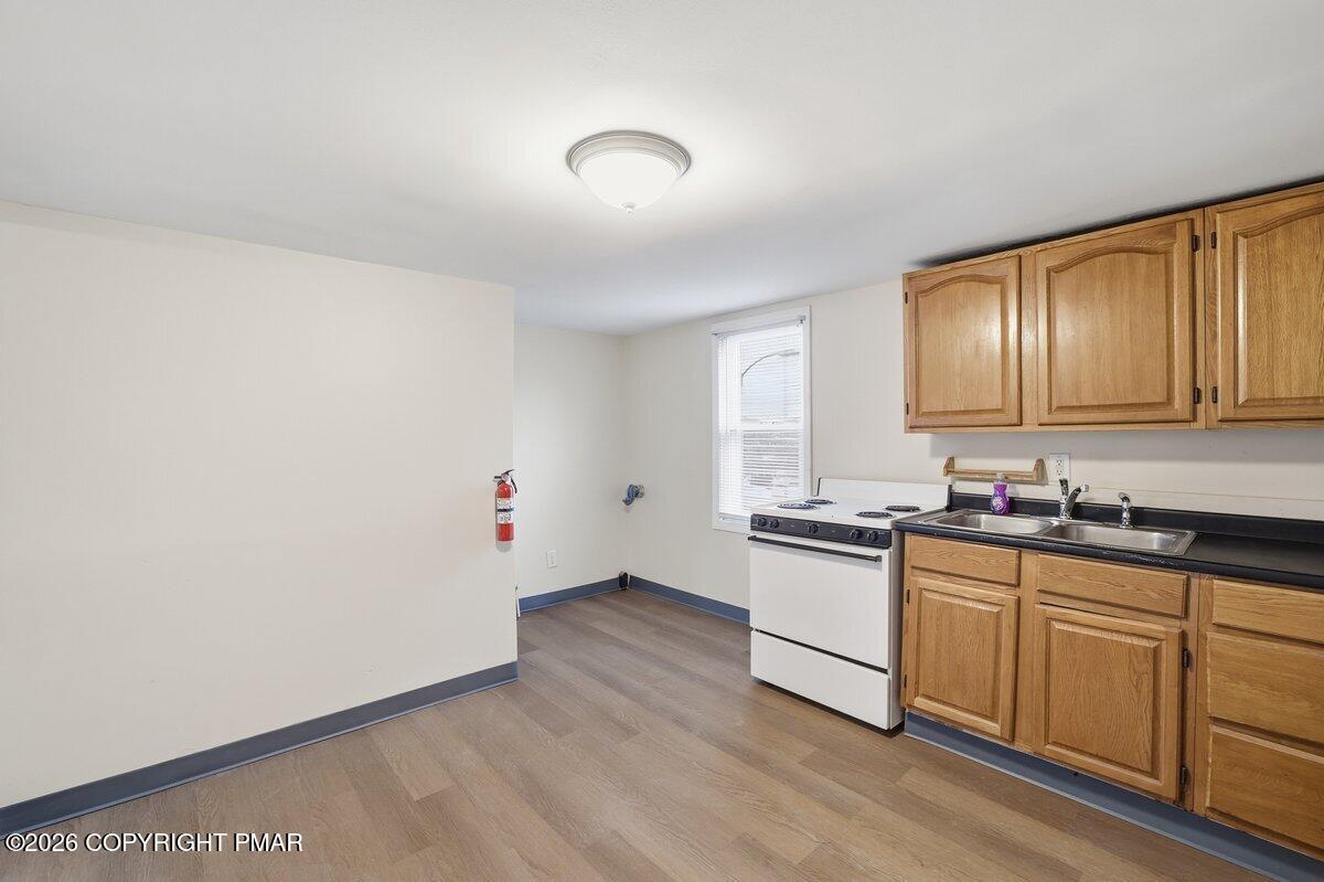 515 Breck Street Scranton, PA 18505 - Photo 31 of 38 a kitchen with granite countertop white cabinets and white appliances