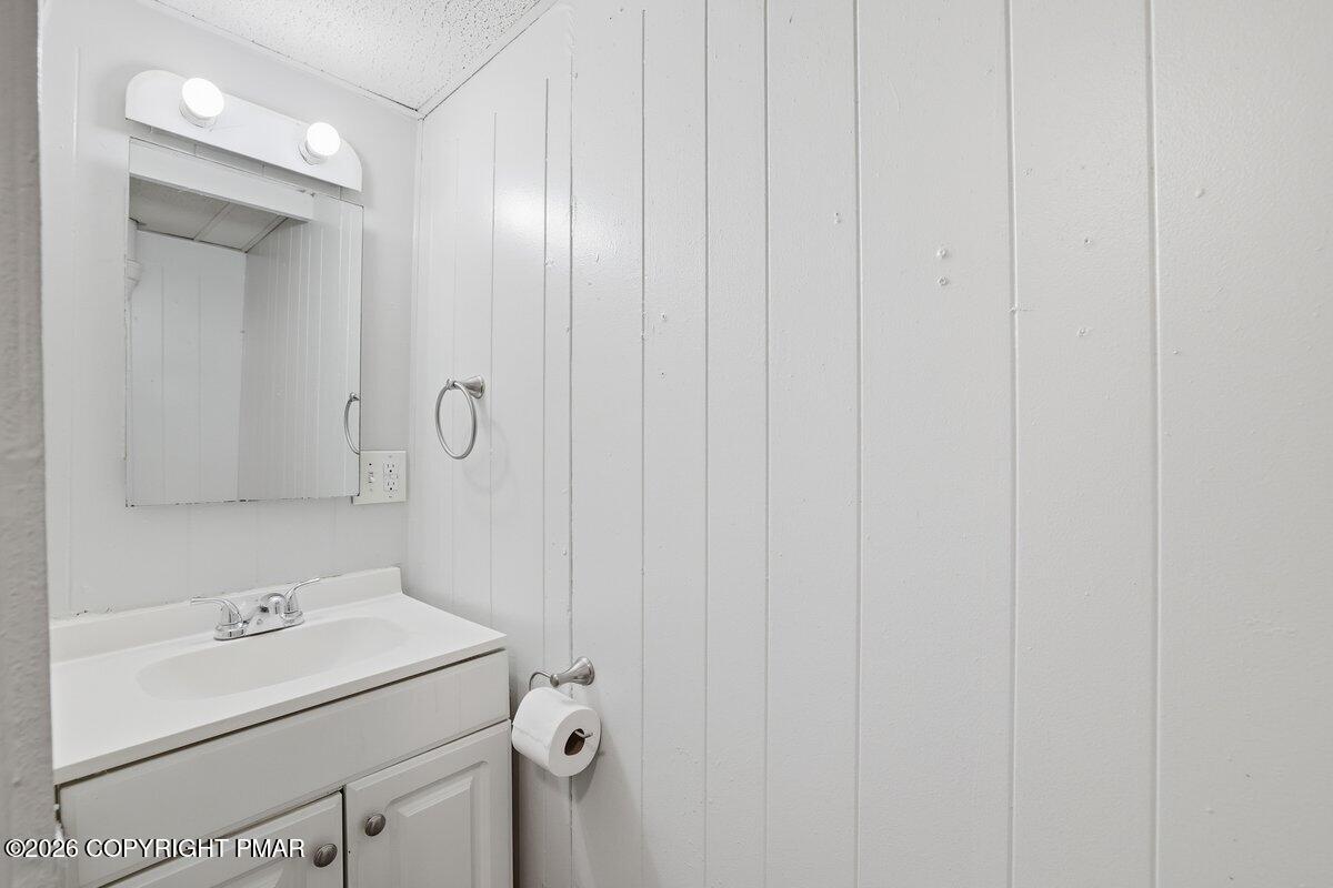 515 Breck Street Scranton, PA 18505 - Photo 35 of 38 a bathroom with a sink and mirror