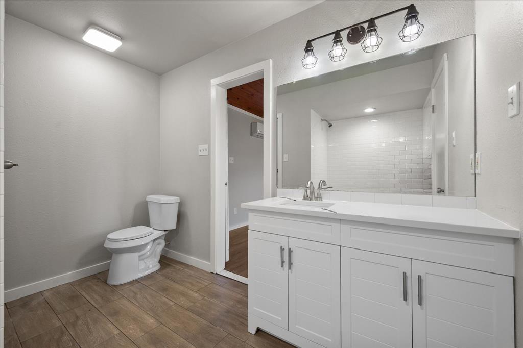 443 County Road 3799 Springtown, TX 76082 - Photo 17 of 33 Full bathroom with dark wood-type flooring, vanity, and a shower