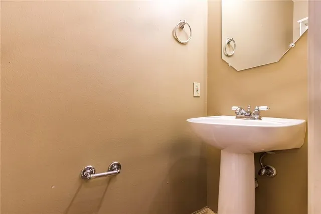 a bathroom with a sink and mirror