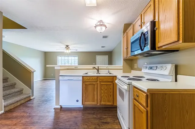 a kitchen with stainless steel appliances granite countertop a stove and a sink