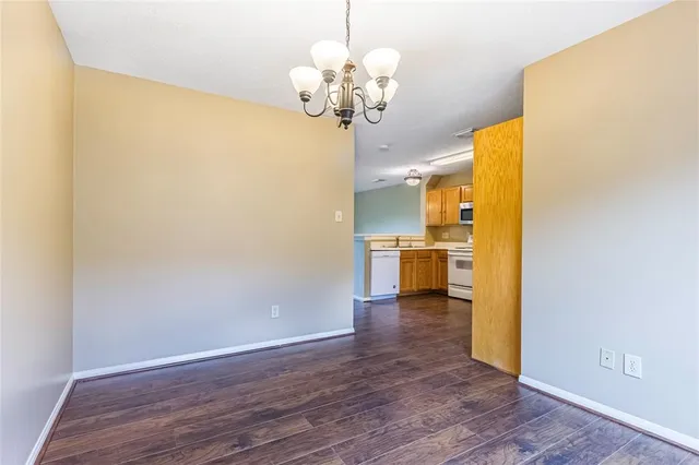 a view of a kitchen with wooden floor and a large window