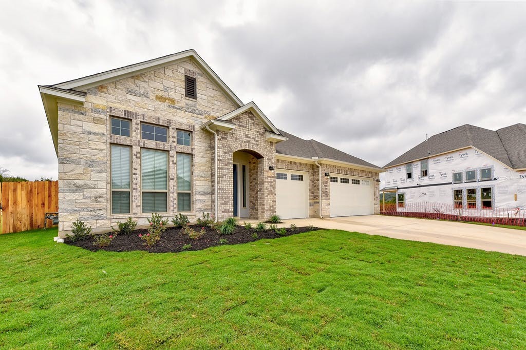 a front view of a house with a yard and garage