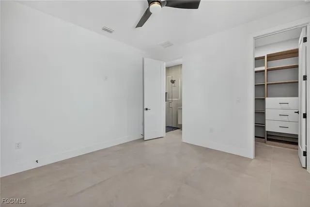 a bathroom with a granite countertop sink toilet and mirror