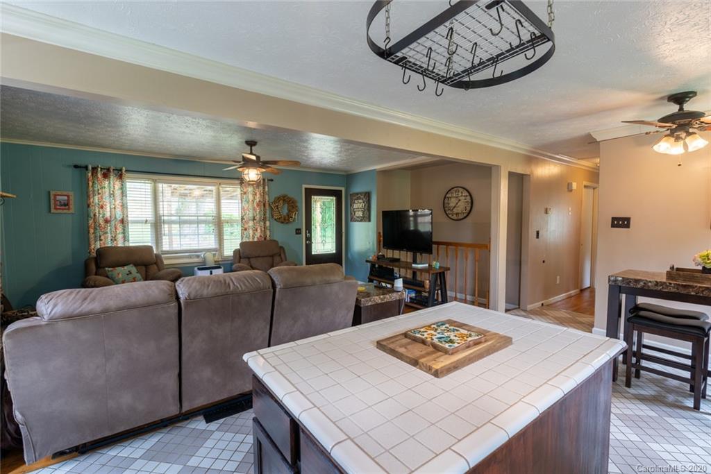 537 Souther Road Fletcher, NC 28732 - Photo 11 of 31 a living room with furniture a table and kitchen view