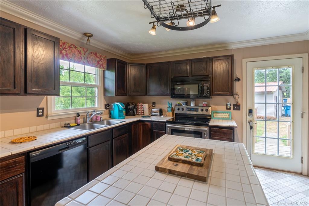 537 Souther Road Fletcher, NC 28732 - Photo 12 of 31 a kitchen with a sink window and stainless steel appliances