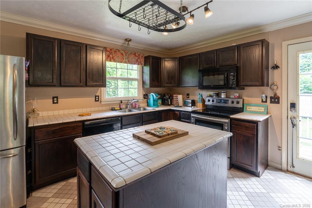 537 Souther Road Fletcher, NC 28732 - Photo 13 of 31 a kitchen with a stove a sink a refrigerator and a microwave