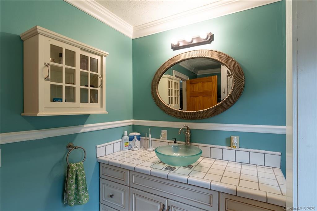 537 Souther Road Fletcher, NC 28732 - Photo 19 of 31 a bathroom with a sink and a mirror