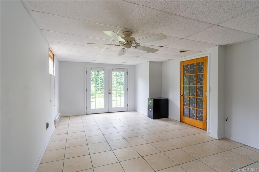 537 Souther Road Fletcher, NC 28732 - Photo 23 of 31 a view of an empty room with a fireplace and a window