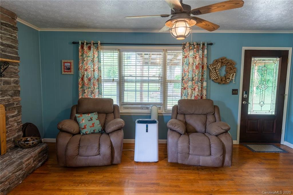 537 Souther Road Fletcher, NC 28732 - Photo 8 of 31 a living room with furniture and a chandelier