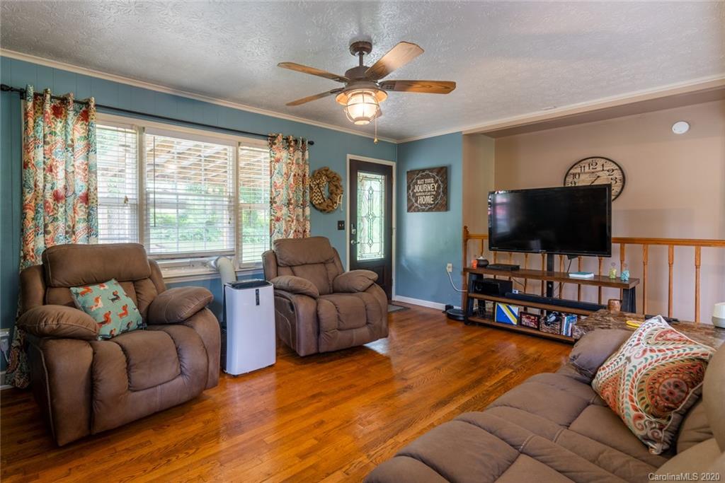 537 Souther Road Fletcher, NC 28732 - Photo 9 of 31 a living room with furniture and a flat screen tv