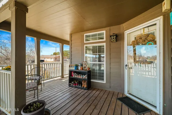 a view of a house with wooden floor outdoor seating